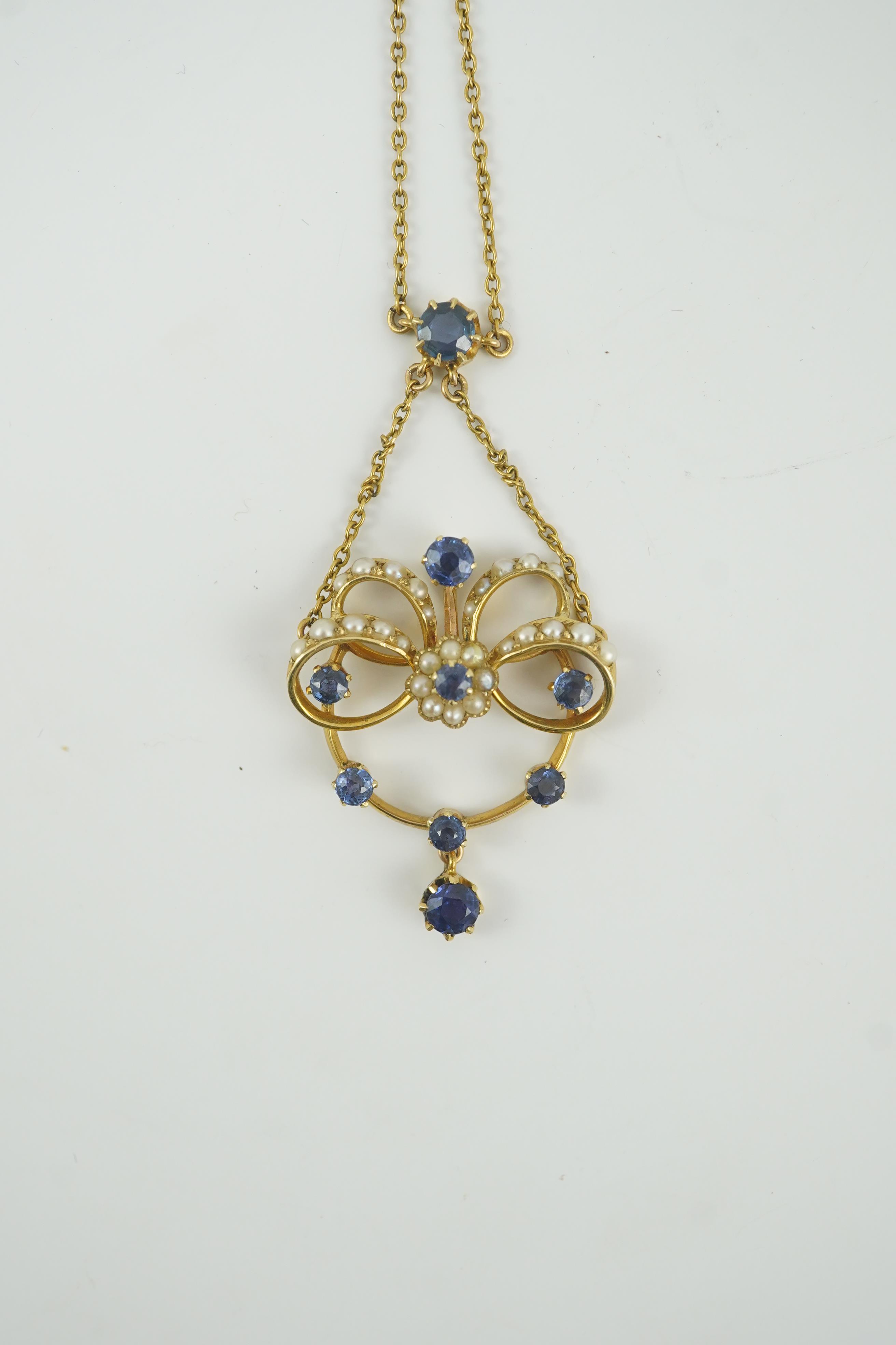 A mid 20th century gold, sapphire and seed pearl cluster set drop pendant necklace